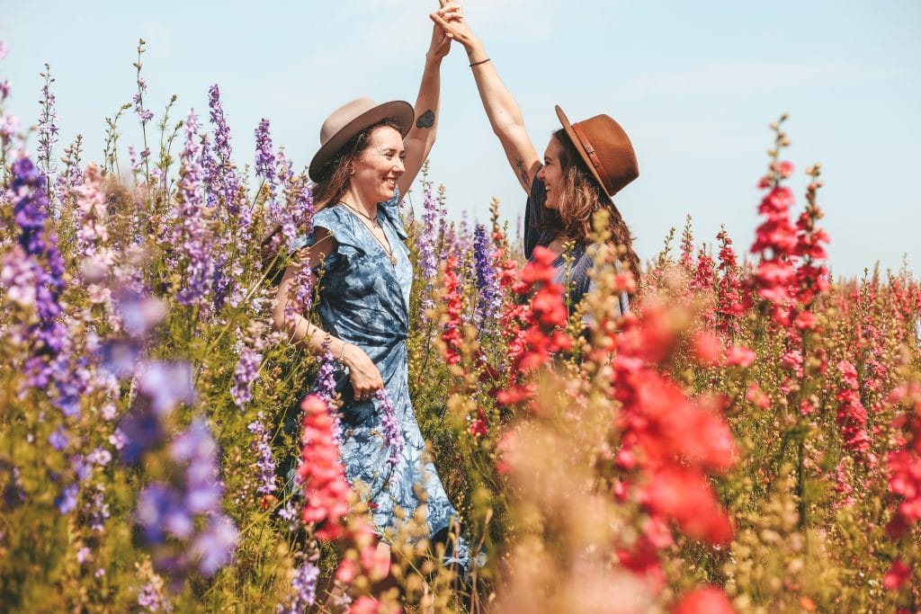 friends-celebrating-in field-of-flowers